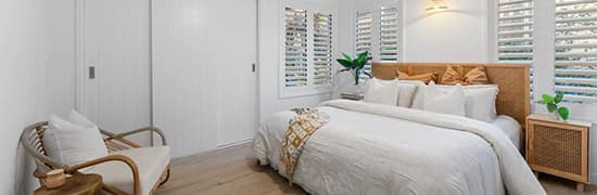 Bedroom with white PVC shutters